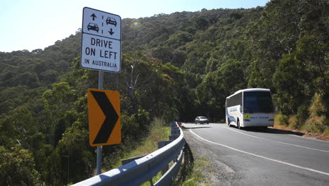 Australia-Great-Ocean-Road-Drive-On-Left-Sign-With-Cars-And-Bus