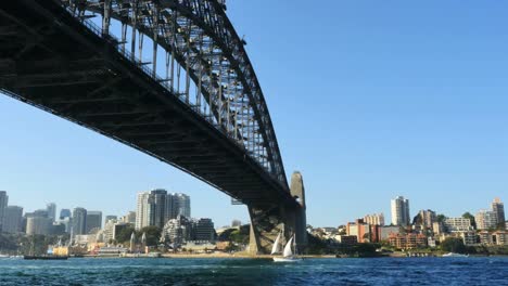 Australia-Sydney-Sailboat-Moves-Under-Harbour-Bridge