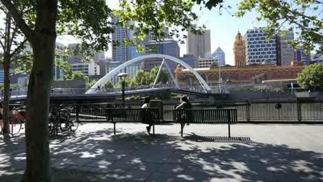 Australien-Melbourne-Fußgängerbrücke-Yarra-River-Jenseits-Von-Mädchen-Auf-Bank