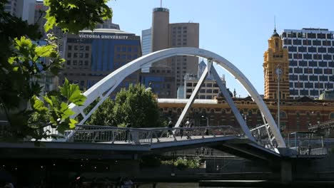 Australia-Melbourne-Foot-Bridge-With-Clock-Tower-Beyond-Pan