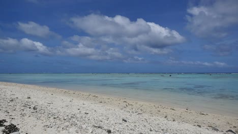 Aitutaki-White-Sand-Beach-And-Lagoon-With-Clouds-And-Bird-Flying