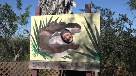 Texas-Gulf-Coast-Tourist-In-Alligator-Mouth-Sign