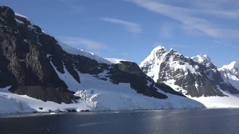 Antarctica-Passing-Black-Cliffs-Toward-Mountain