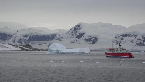 Antarctica-Red-Expedition-Ship-And-Iceberg