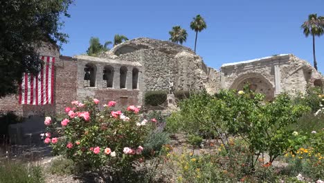 California-San-Juan-Capistrano-Mission-Bell-Wall-With-Flag-And-Roses