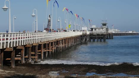 California-Santa-Cruz-Pier-With-Flags-And-Waves