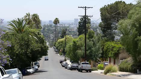 California-Los-Angeles-Car-Driving-Up-Street-On-Hill