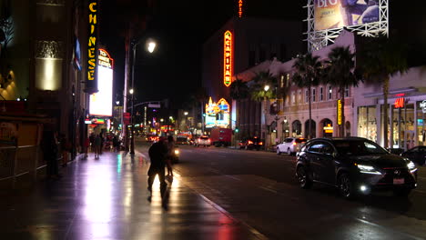 California-Tourists-Take-Pictures-Of-Their-Friends-On-Hollywood-Boulevard-At-Night