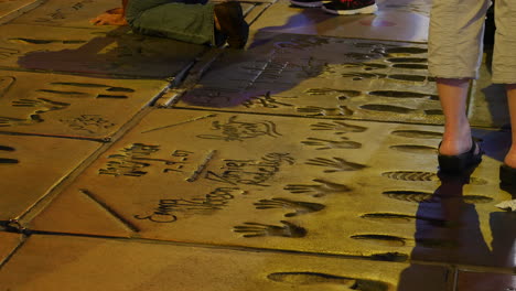 Los-Angeles-Hollywood-Walk-Of-Fame-With-Hand-Prints-In-Concrete-At-Night