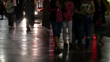 Los-Angeles-People-Walking-On-Hollywood-Sidewalk-At-Night-With-Reflections