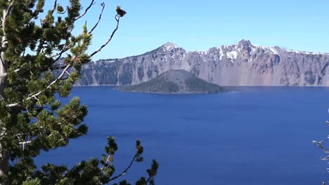 Oregon-Crater-Lake-Evergreen-Tree-Frames-View-With-Wizard-Island-Pan-And-Zoom