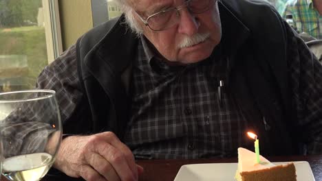 Old-Man-Looks-At-Birthday-Candle-Tilt