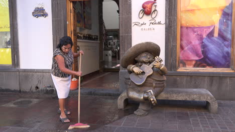 Mexico-Tlaquepaque-Woman-Sweeps-By-Statue