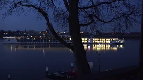 Netherlands-River-Cruise-Boat-Passes-Tree-Before-Dawn