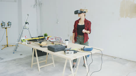 Woman-using-virtual-reality-goggles-in-workshop-