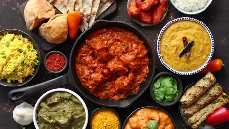 Various-Indian-dishes-on-a-table--Spicy-chicken-Tikka-Masala-in-iron-pan
