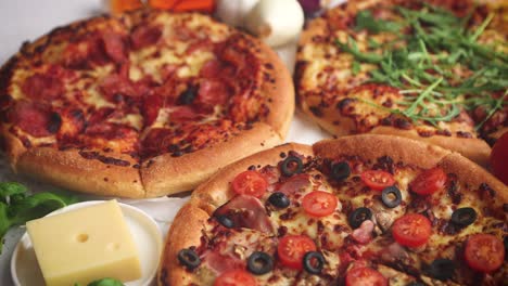Three-american-style-pizzas-served-on-a-table