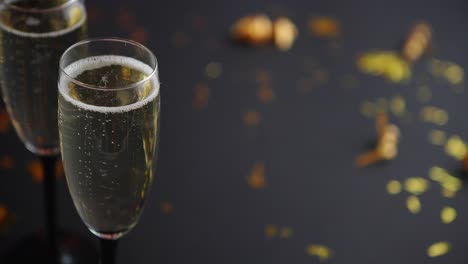 Two-glasses-full-of-sparkling-champagne-wine-with-golden-decoration