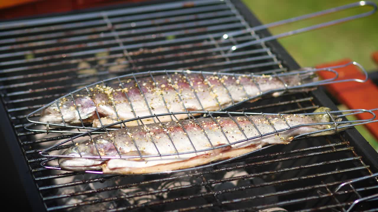 Premium stock video - Tasty whole fishes placed on barbecue grill