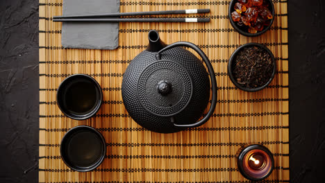 Asian-green-tea-set-on-bamboo-mat