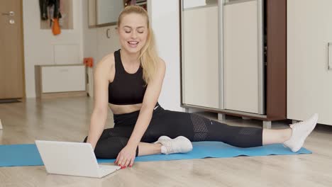 Premium Photo  Attractive young woman doing yoga stretching yoga online at  home.