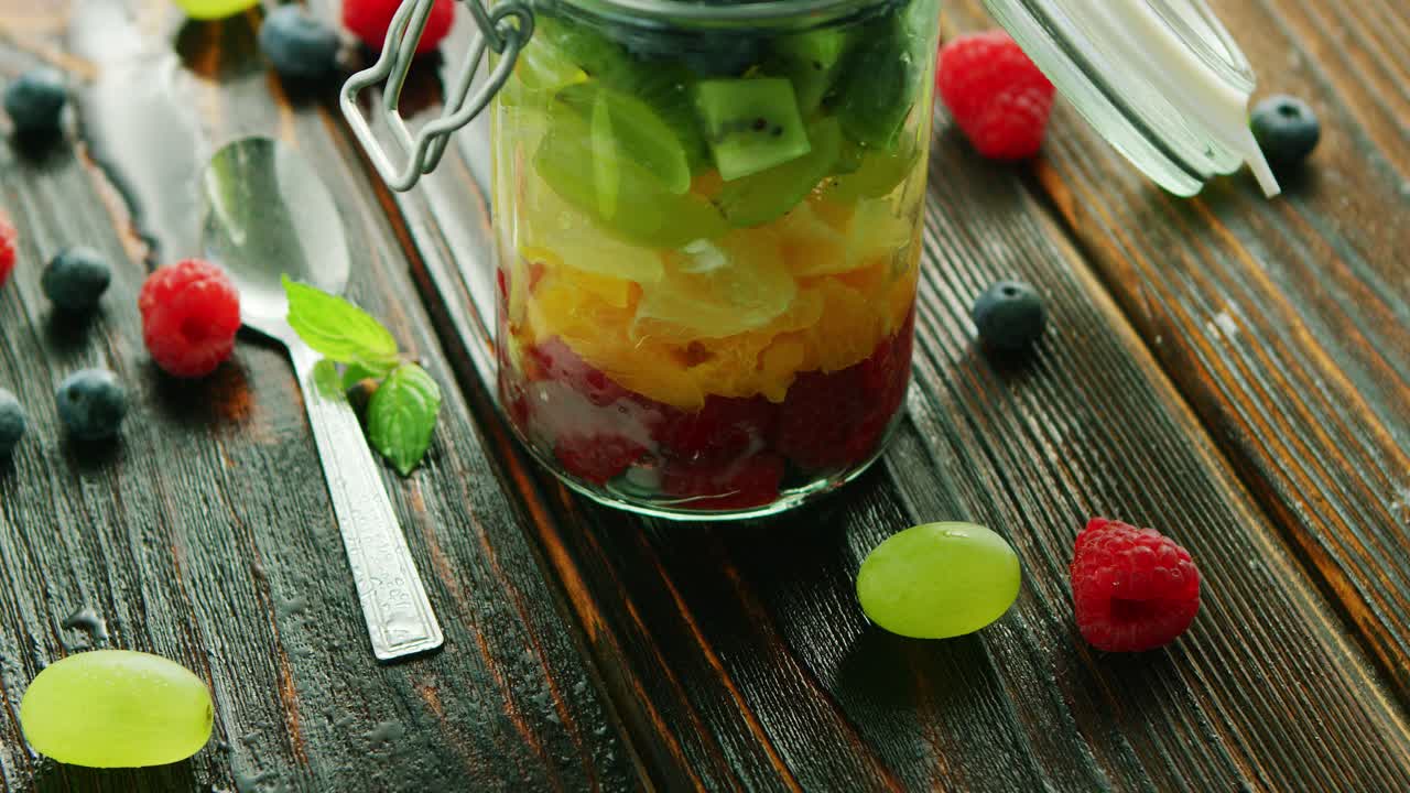 Premium stock video Fresh fruits in glass jar