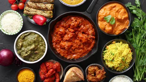 Various-Indian-dishes-on-a-table--Spicy-chicken-Tikka-Masala-in-iron-pan