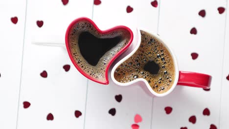 Two-heart-shaped-coffee-cups-conected-with-each-other