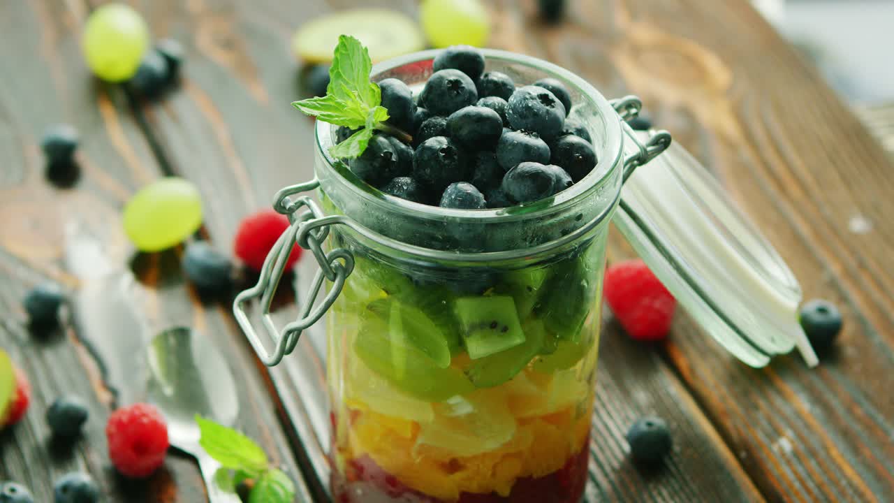Premium stock video fresh fruits in glass jar