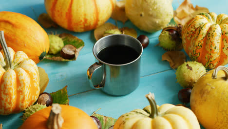 Metal-cup-of-coffee-with-pumpkins