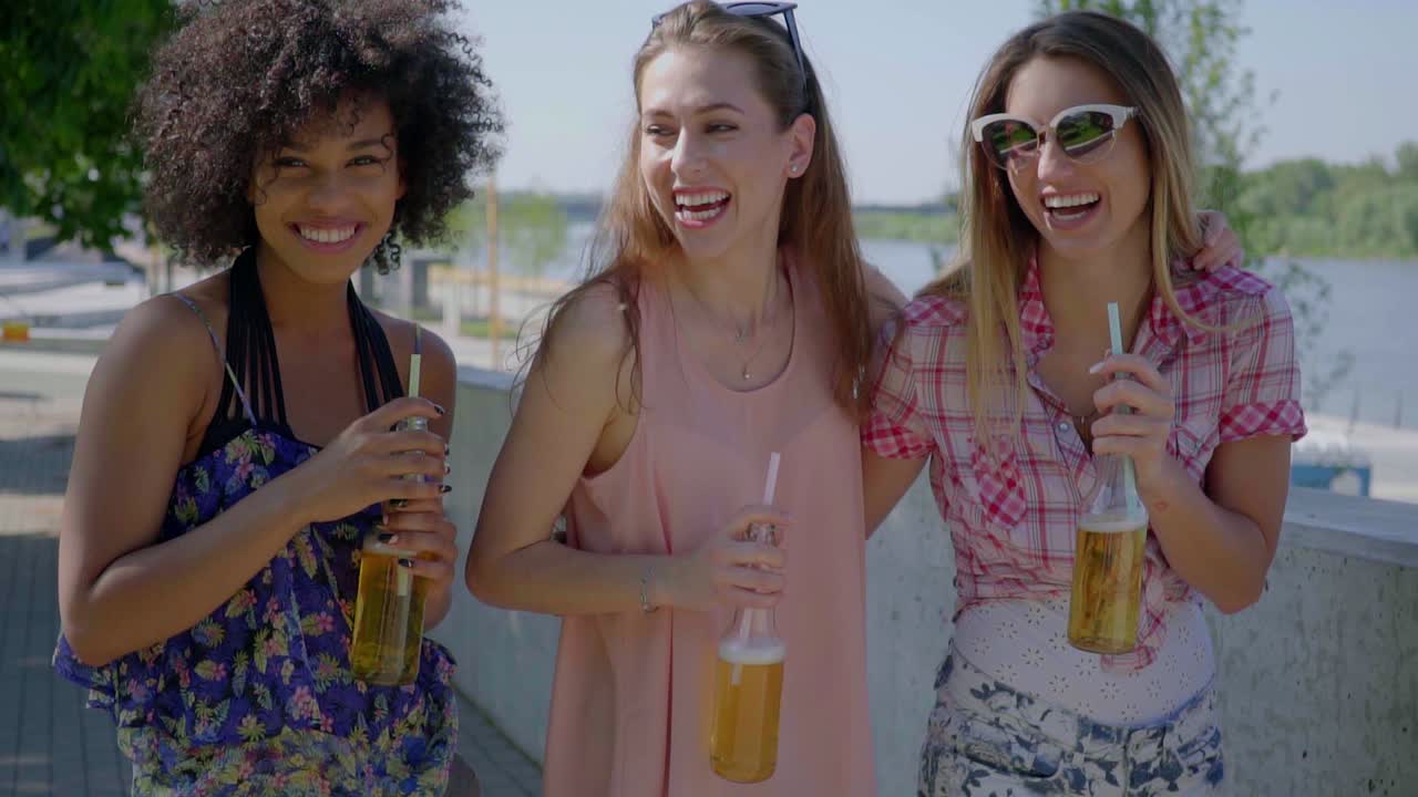 Premium stock video - Happy women drinking beer in city