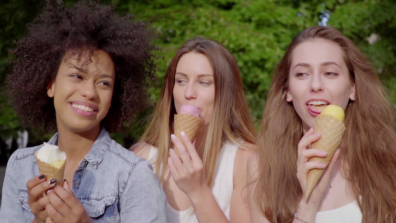 Premium Photo  Multiethnic friends in an ice cream parlor sitting eating  an ice cream summer showing off the ice creams