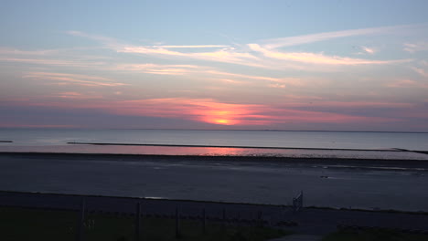 Germany-sunset-on-Wadden-Sea-with-insects-flying-around-zoom-in