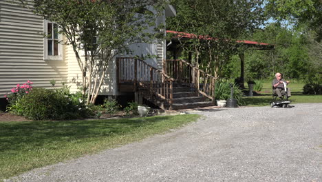 Louisiana-man-with-scooter-on-gravel-road