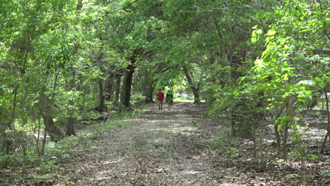 Louisiana-woman-and-boy-on-woodland-path-zoom-in