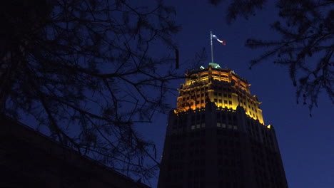 San-Antonio-tower-with-flag-at-night