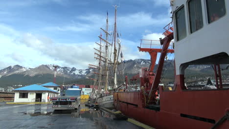 Argentina-Ushuaia-red-ship-with-masts-and-mountains