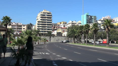 Chile-Vina-del-Mar-woman-in-shade-and-palms-on-curved-road