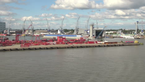 Netherlands-Rotterdam-red-containers-on-dock-and-cranes