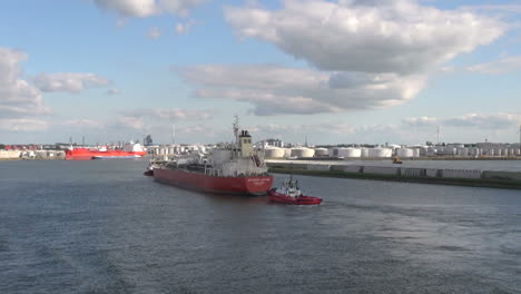 Netherlands-Rotterdam-red-tanker-and-tug-pass-refinery-14a