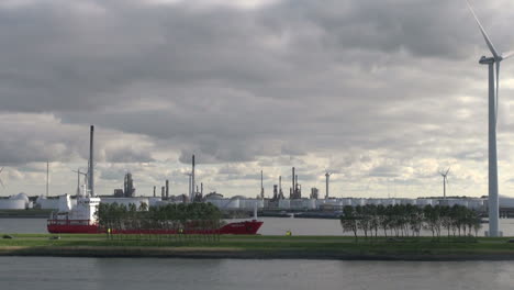 Netherlands-Rotterdam-refinery-car-passing-tanker-below-windmill-11