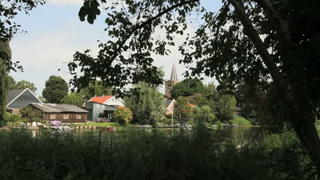 Netherlands-canal-through-village-and-church-spire