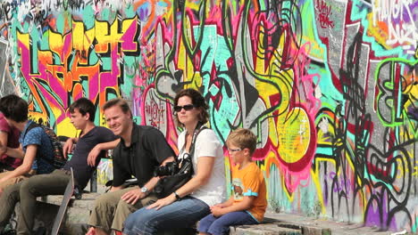 Germany-Berlin-Mauerpark-graffiti-behind-tourists-editorial