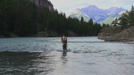 Canada-Alberta-Banff-Bow-River-fisherman-wading-and-mountain-7