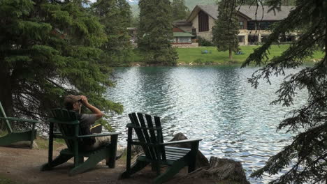 Canada-Alberta-Jasper-Lodge-wooden-chair-by-pond-17