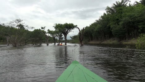 Amazon-canoe-follows-canoe-through-jungle