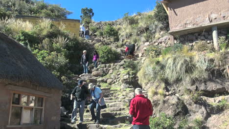 Peru-Taquile-tourists-on-steep-steps-on-hillside-23