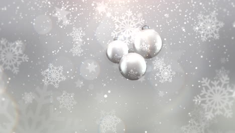 Animated-closeup-motion-silver-balls-and-snowflakes-on-white-background