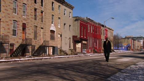 People-walk-on-the-streets-in-a-North-Baltimore-slum-1