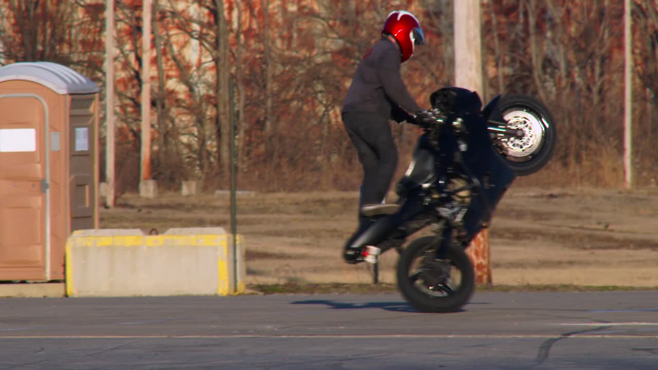 A Rider Performs Stunts On A Motorcycle In A Parking Lot 2 Free Stock Video  Footage Download Clips Sports